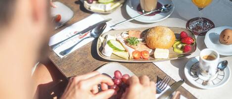 A breakfast setting with a variety of food items and beverages on a table.