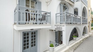 A white building with balconies and a sign for "Golden Beach Studios." - Golden Beach Studios (Naxos)