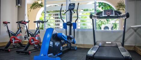 A gym with stationary bikes, an elliptical, and a treadmill.