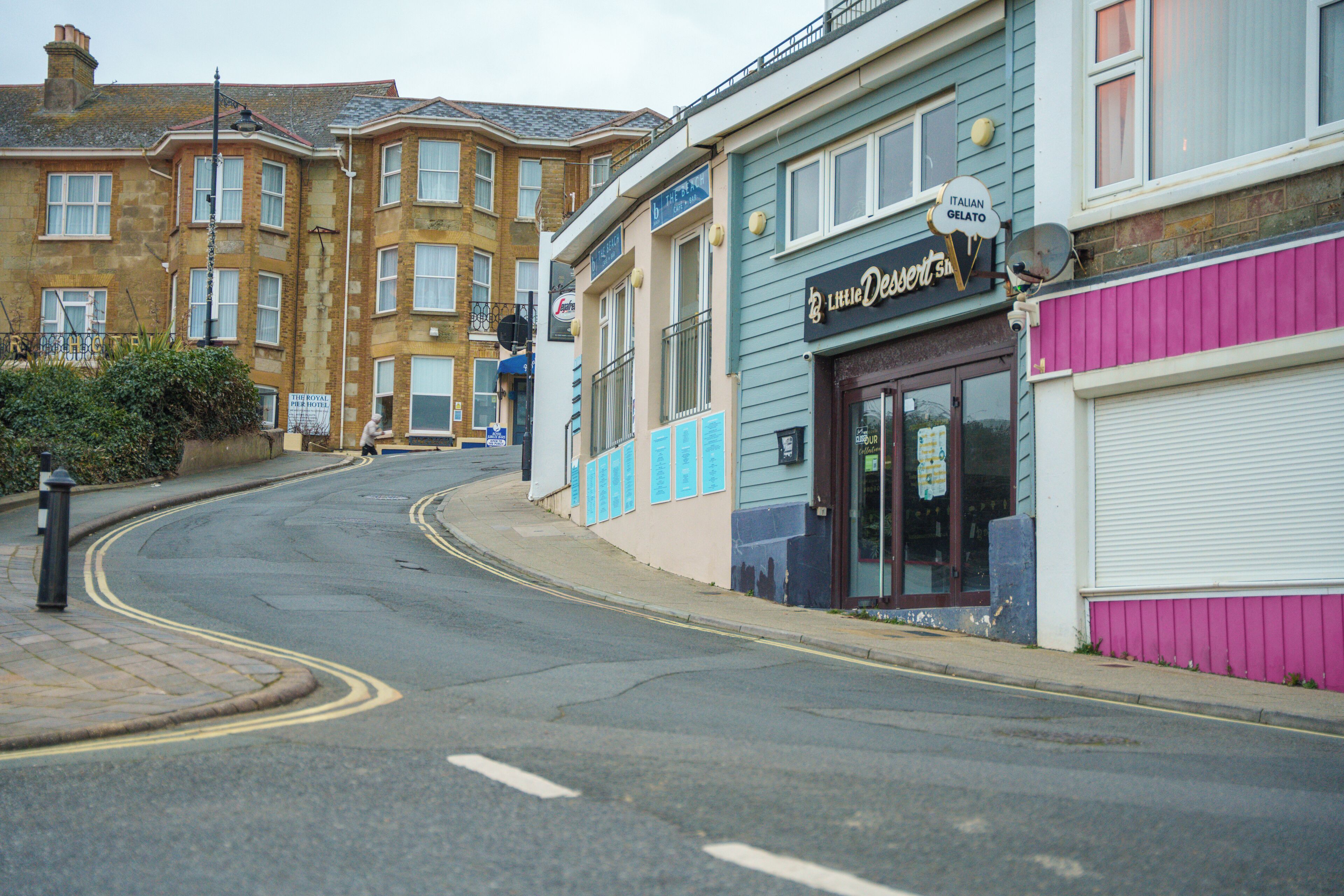 A street view with buildings, including a shop named 'Little Desserts'.