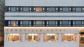 Welcome to the Trouville Hotel, a modern building with a prominent entrance and windows on each floor.