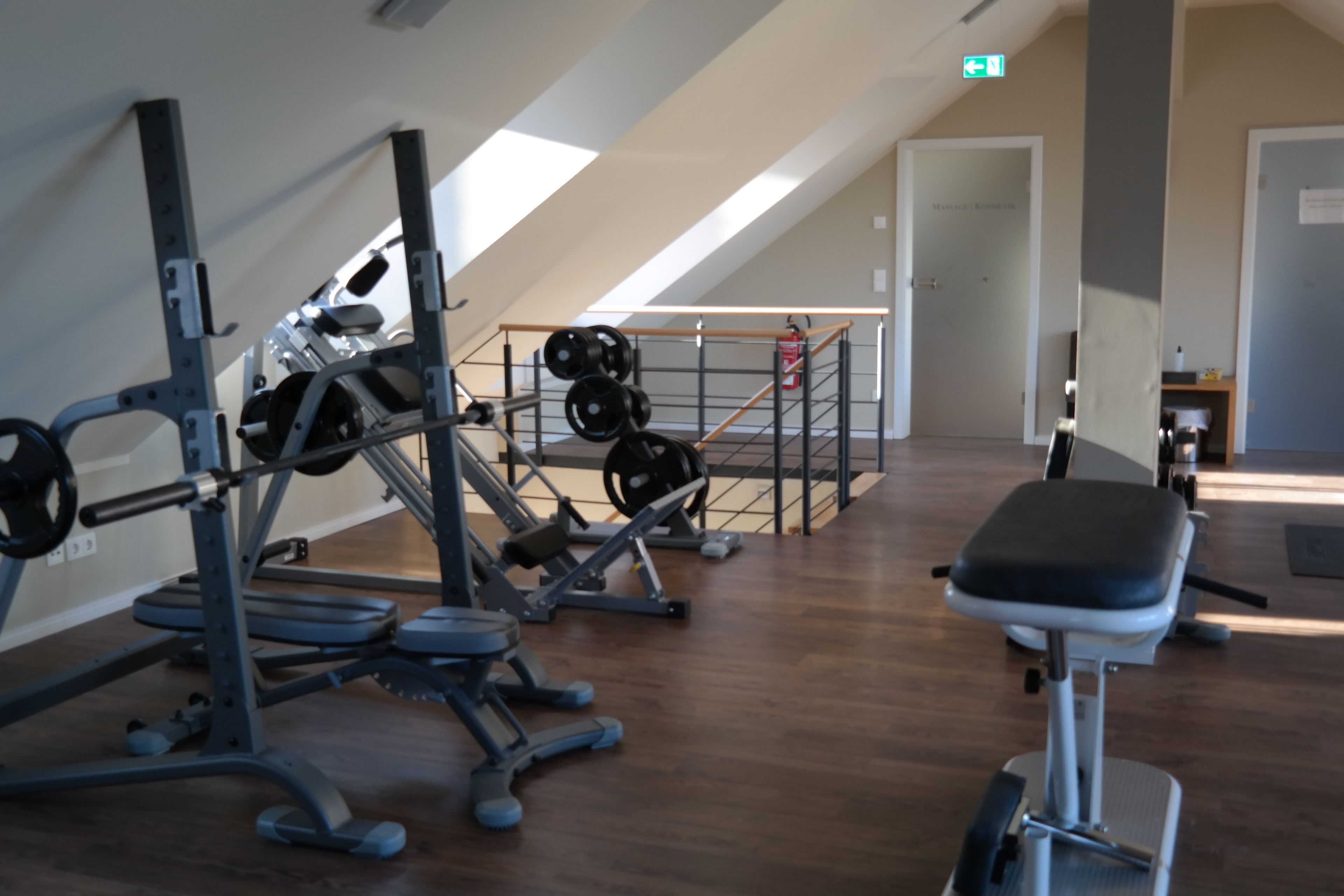 A gym with various exercise equipment, including weight machines and free weights.