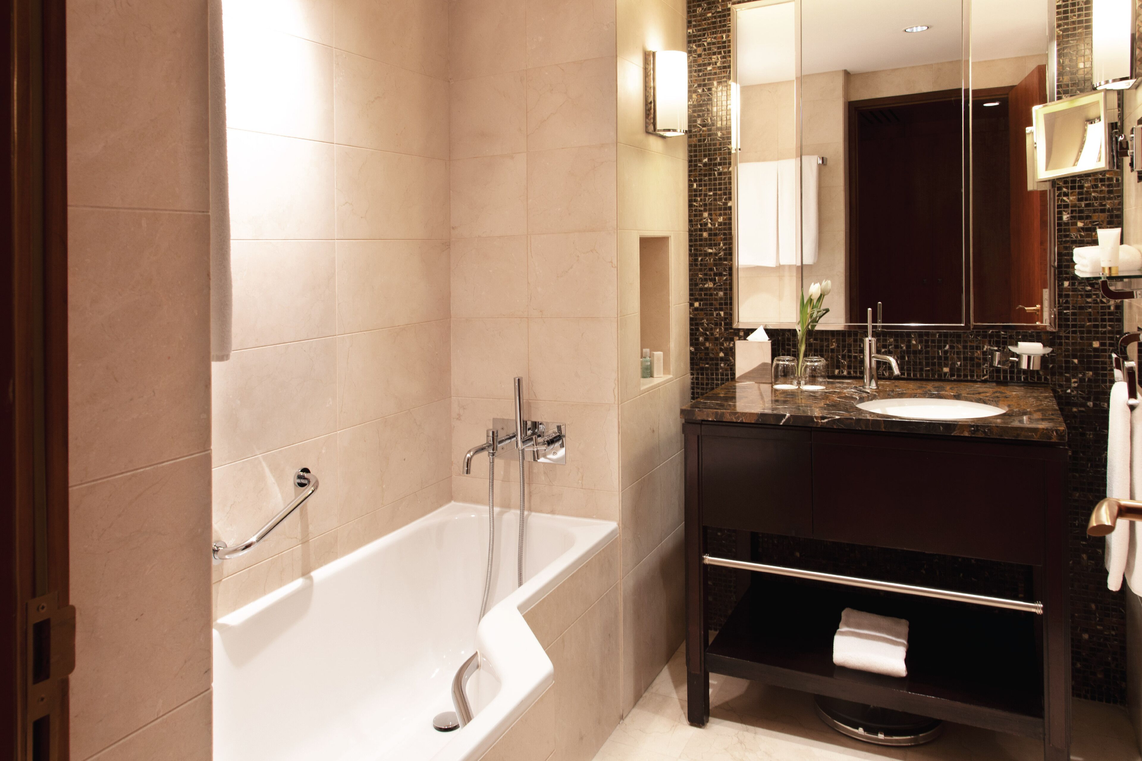 Un baño moderno con una bañera, un lavabo y tocador.