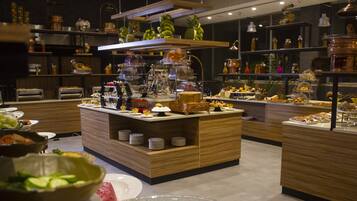 A buffet setup with various food items and a central serving station.