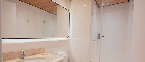 A modern bathroom with a sink, toilet, and shower.