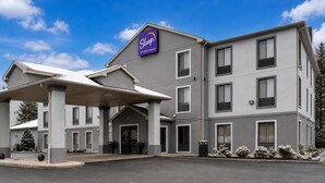 A Sleep by Choice hotel with a covered entrance, multiple floors, and a parking lot.