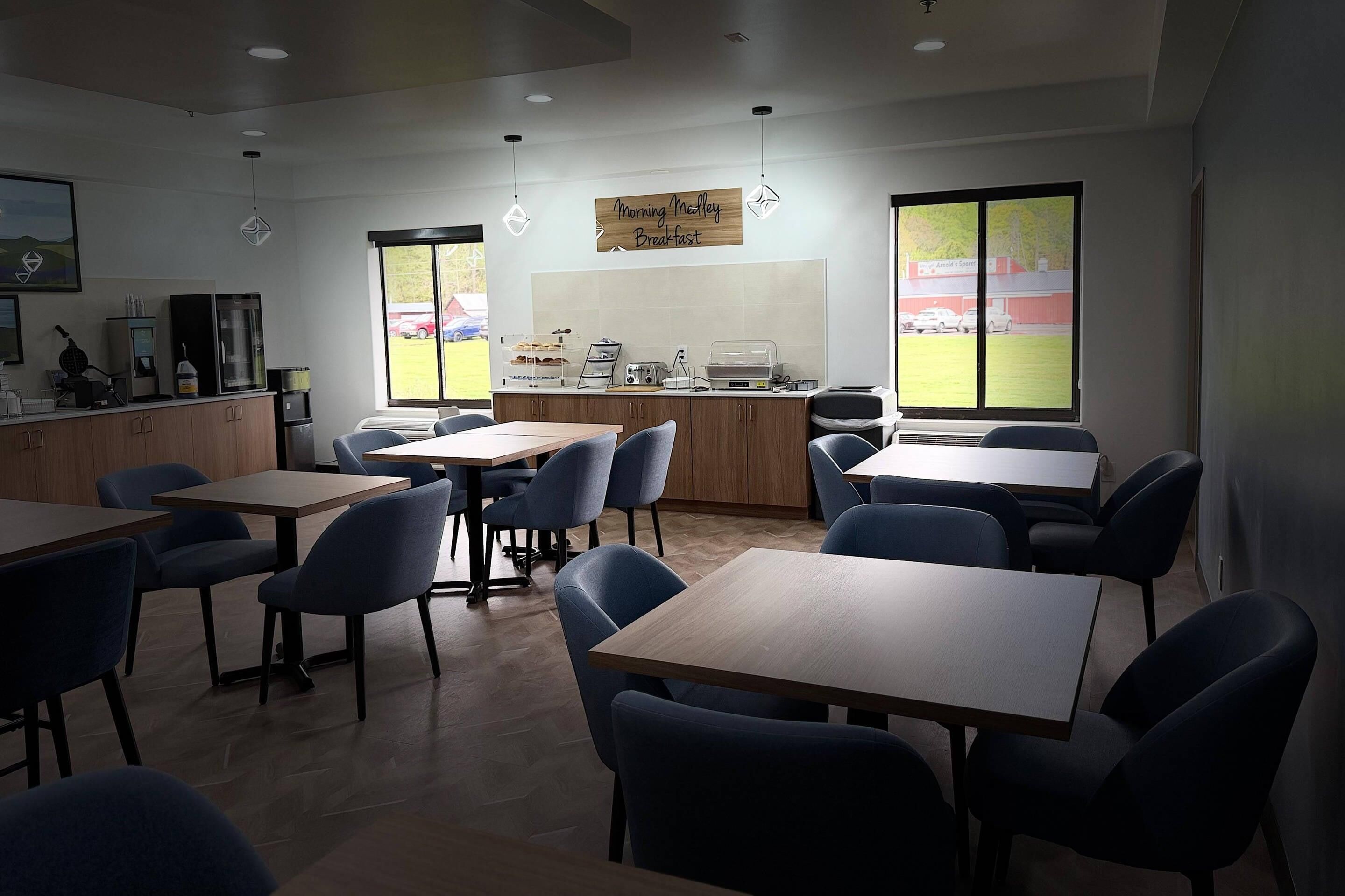 A breakfast area with tables, chairs, a counter, and a sign that reads 'Morning Melty Breakfast.'