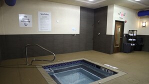 A pool area with a no-diving sign, spa rules, and an exit door.