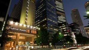 A high-rise building with illuminated signage reading "CASTLE PLAZA". - Castle Plaza Hotel (Nagoya)
