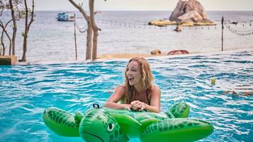 Guests can enjoy a refreshing swim in the pool overlooking the sea.