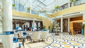A spacious lobby with a high ceiling, modern furniture, and a patterned floor. - InterContinental Doha The City by IHG (Doha)