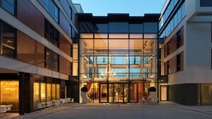 A modern hotel entrance with a glass facade, a central atrium, and a spa sign. - Harbour Hotel Guildford (Guildford)