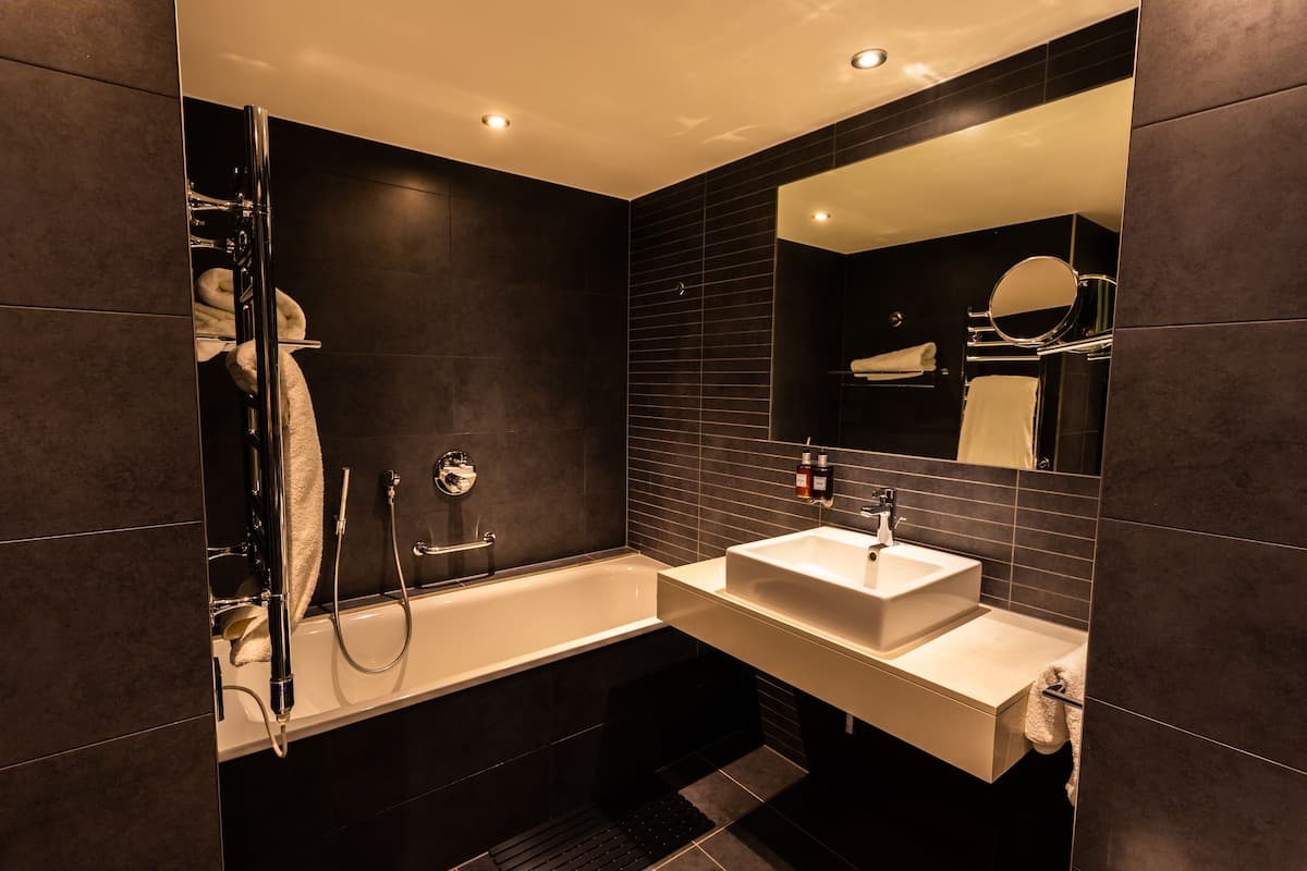 shower, designer toiletries, hair dryer, towels