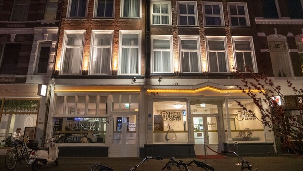 A hotel with a ground floor entrance, multiple windows, and a visible sign for the hotel center. - Hotel Hague Center (The Hague)