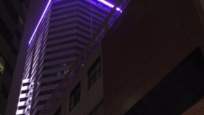 A high-rise building with a distinctive purple neon light along the top edge. - Wyndham Grand Bangsar Kuala Lumpur (Kuala Lumpur)