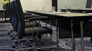 A conference room with rows of black office chairs, a long table, and a carpeted floor. - Wyndham Grand Bangsar Kuala Lumpur (Kuala Lumpur)