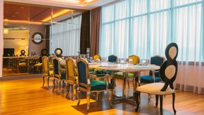 A conference room with a large table, multiple chairs, and a mirror on the wall. - Wyndham Grand Bangsar Kuala Lumpur (Kuala Lumpur)