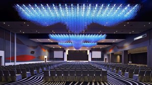 A conference room with rows of chairs, a large screen, and a ceiling light installation. - Wyndham Grand Bangsar Kuala Lumpur (Kuala Lumpur)