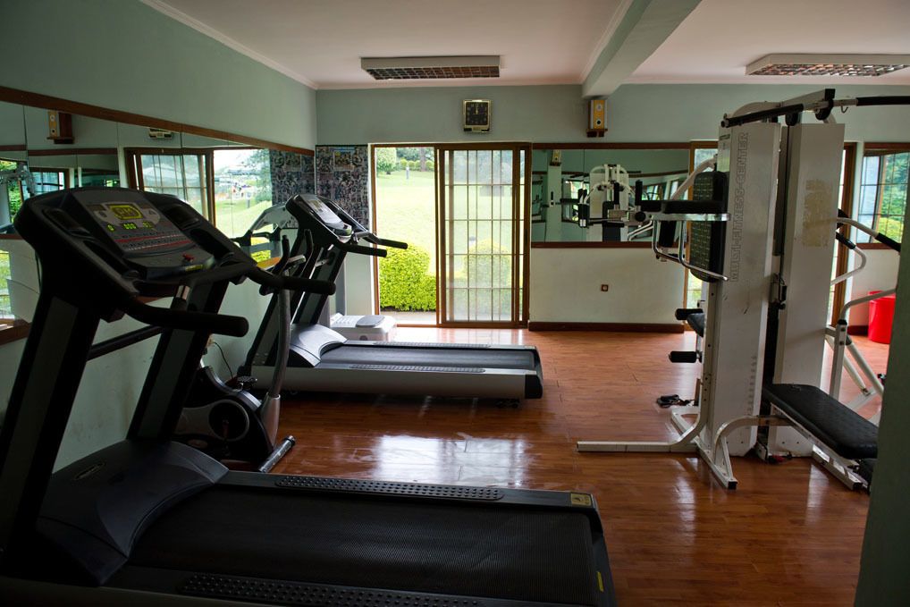 A gym with treadmills, a stationary bike, and a weight machine.