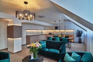 Deluxe Suite | Living area | 55-inch flat-screen TV with digital channels, TV