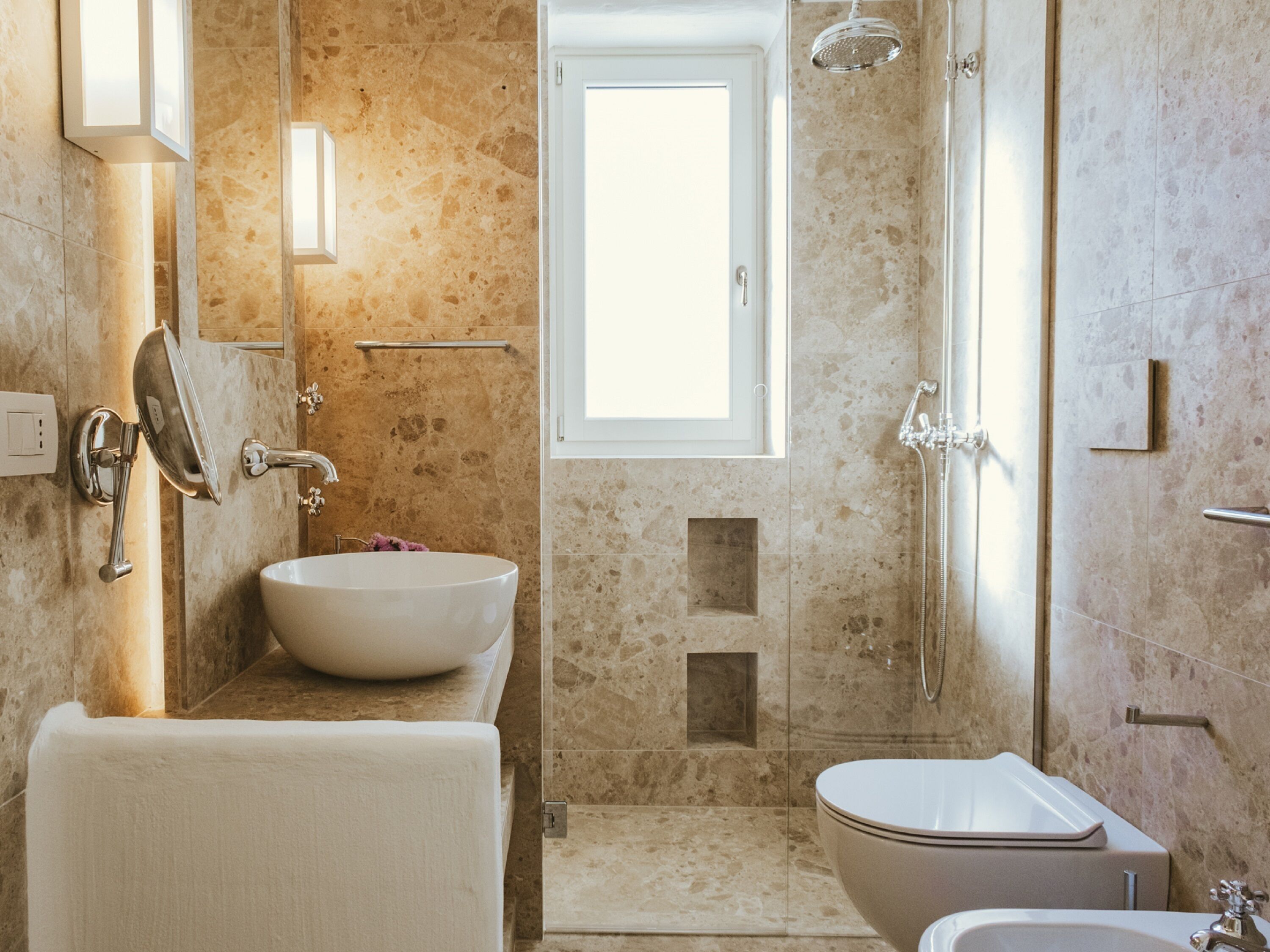 A modern bathroom with a freestanding bathtub, a toilet, and a shower area.
