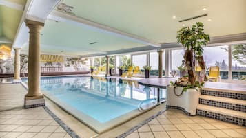 Indoor pool, pool umbrellas, pool loungers