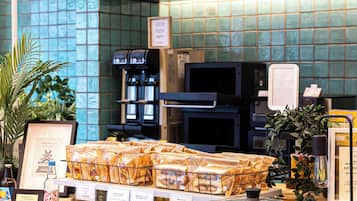 A counter with a sign reading 'Beer Hot Water' and a display of packaged food items.