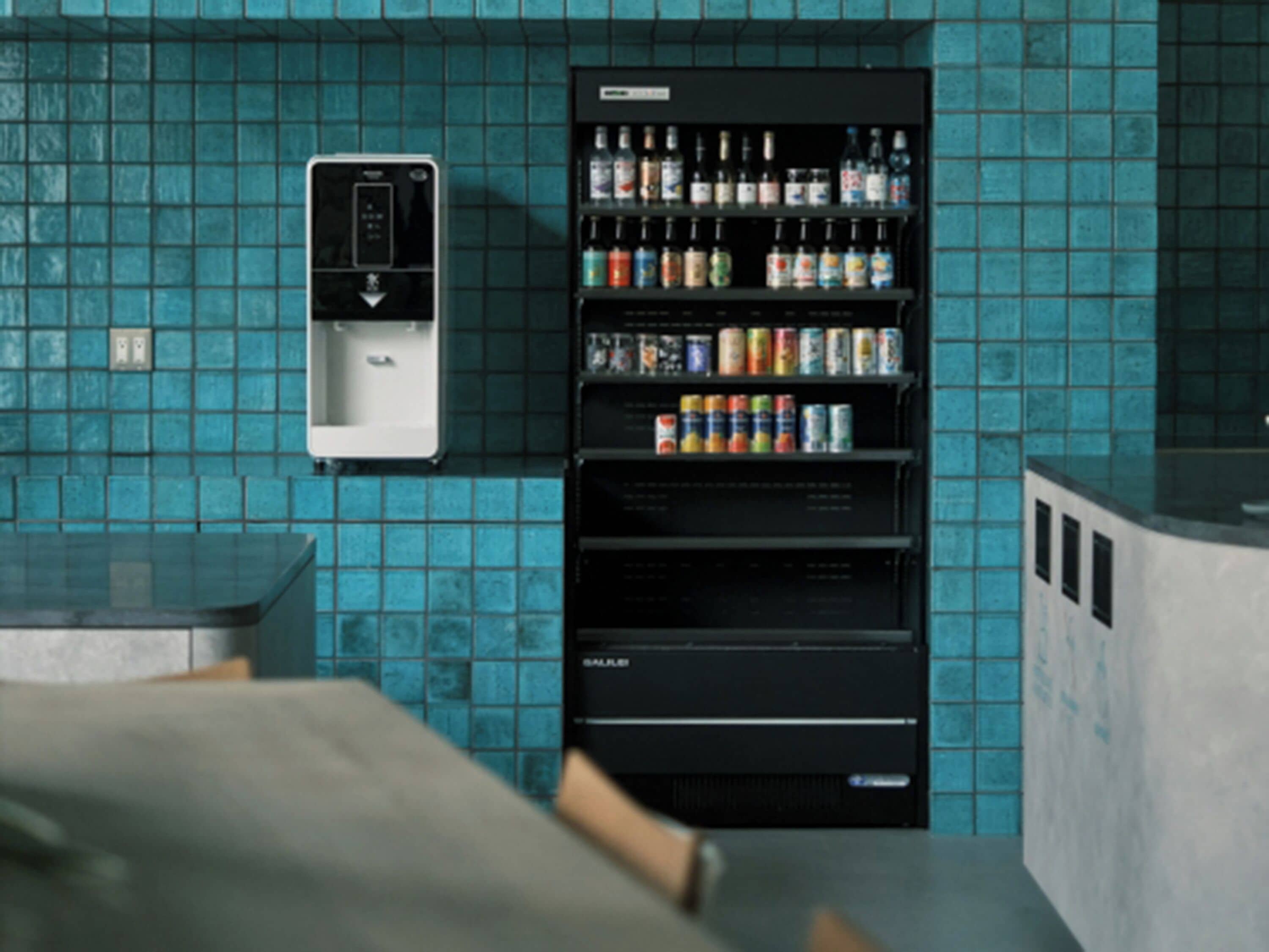 A restroom with a vending machine stocked with beverages and toiletries.
