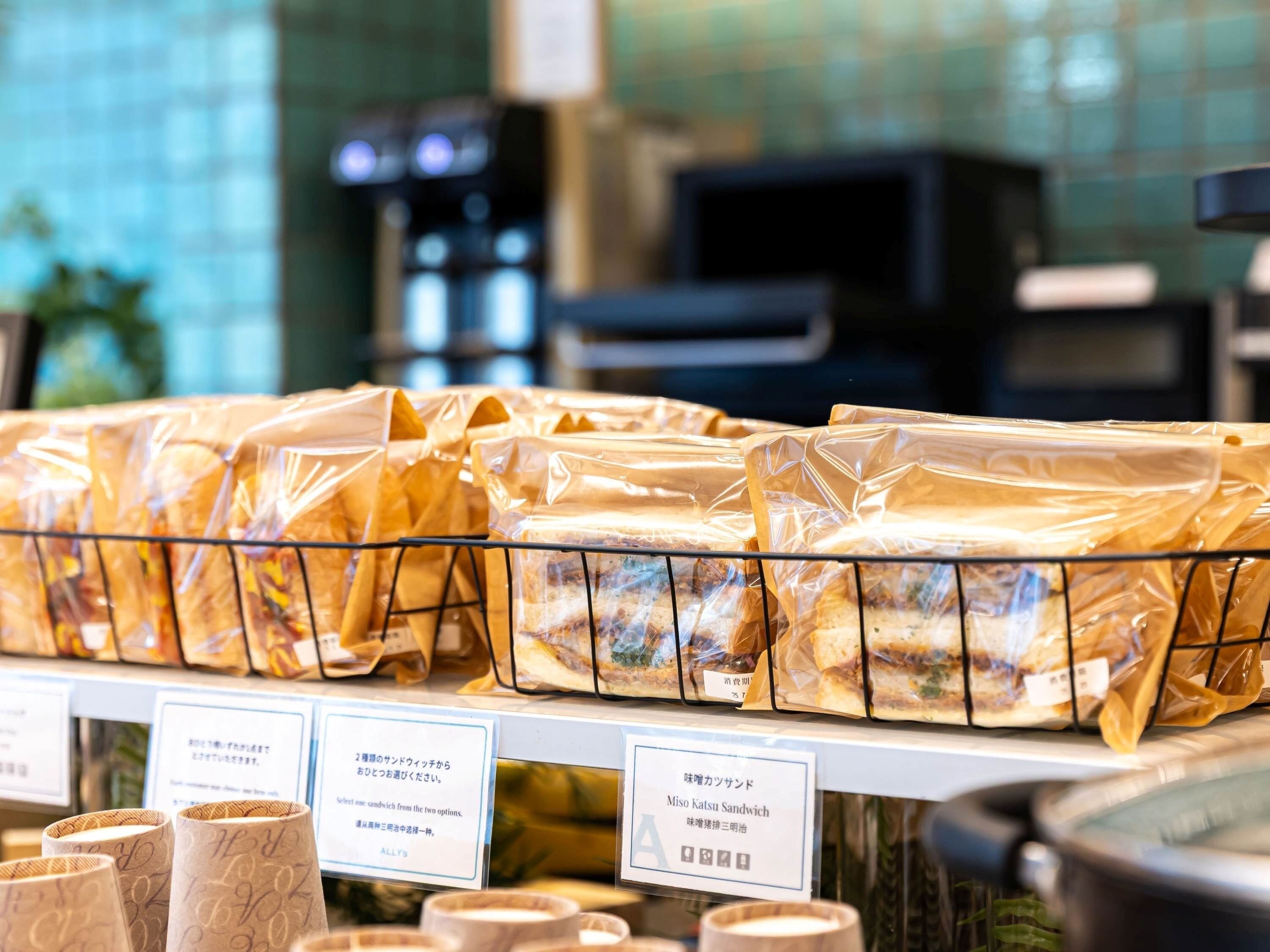 A display of packaged sandwiches with labels in a store.