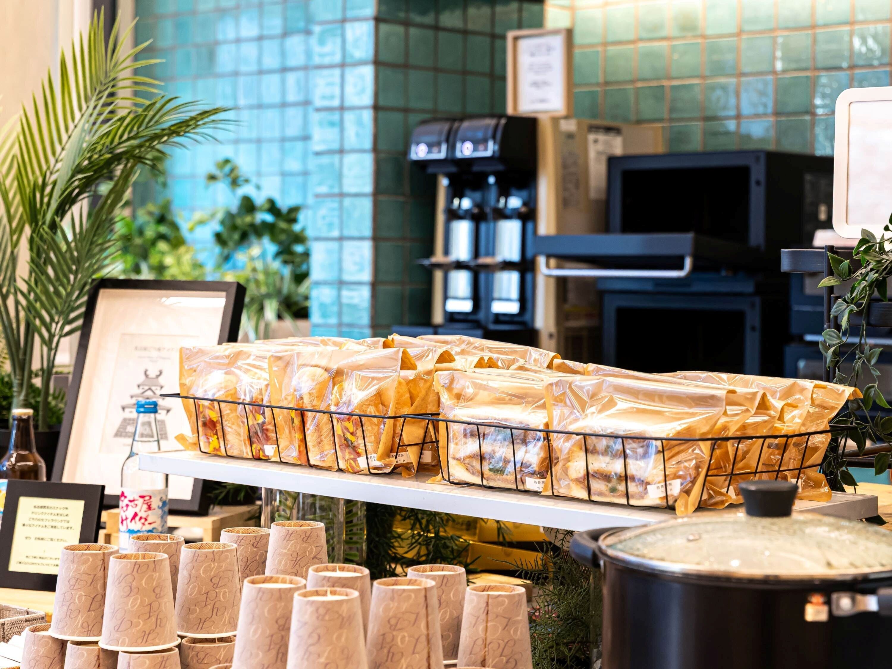A food display with packaged items and paper cups.