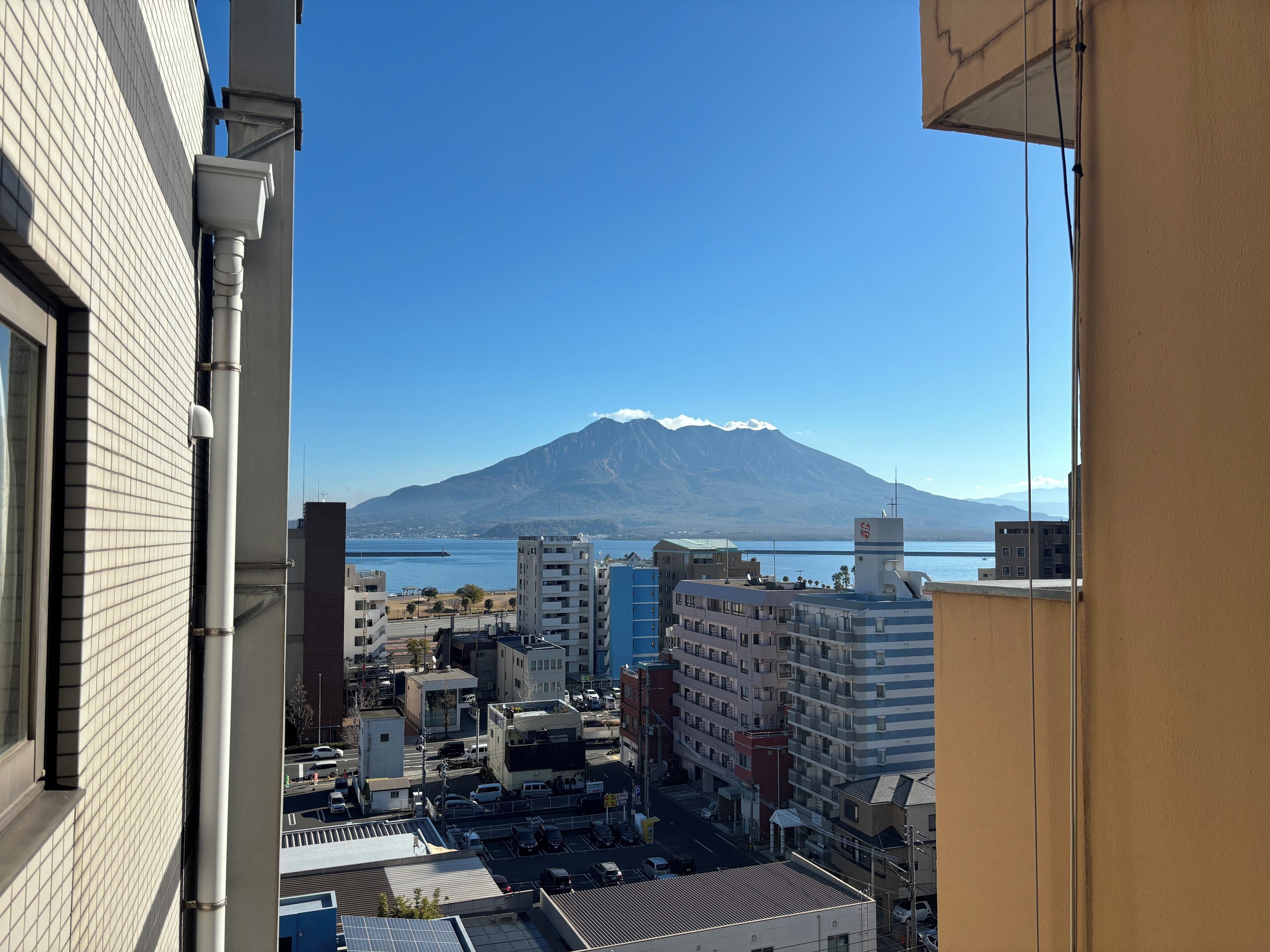 A cityscape with a mountain in the background.