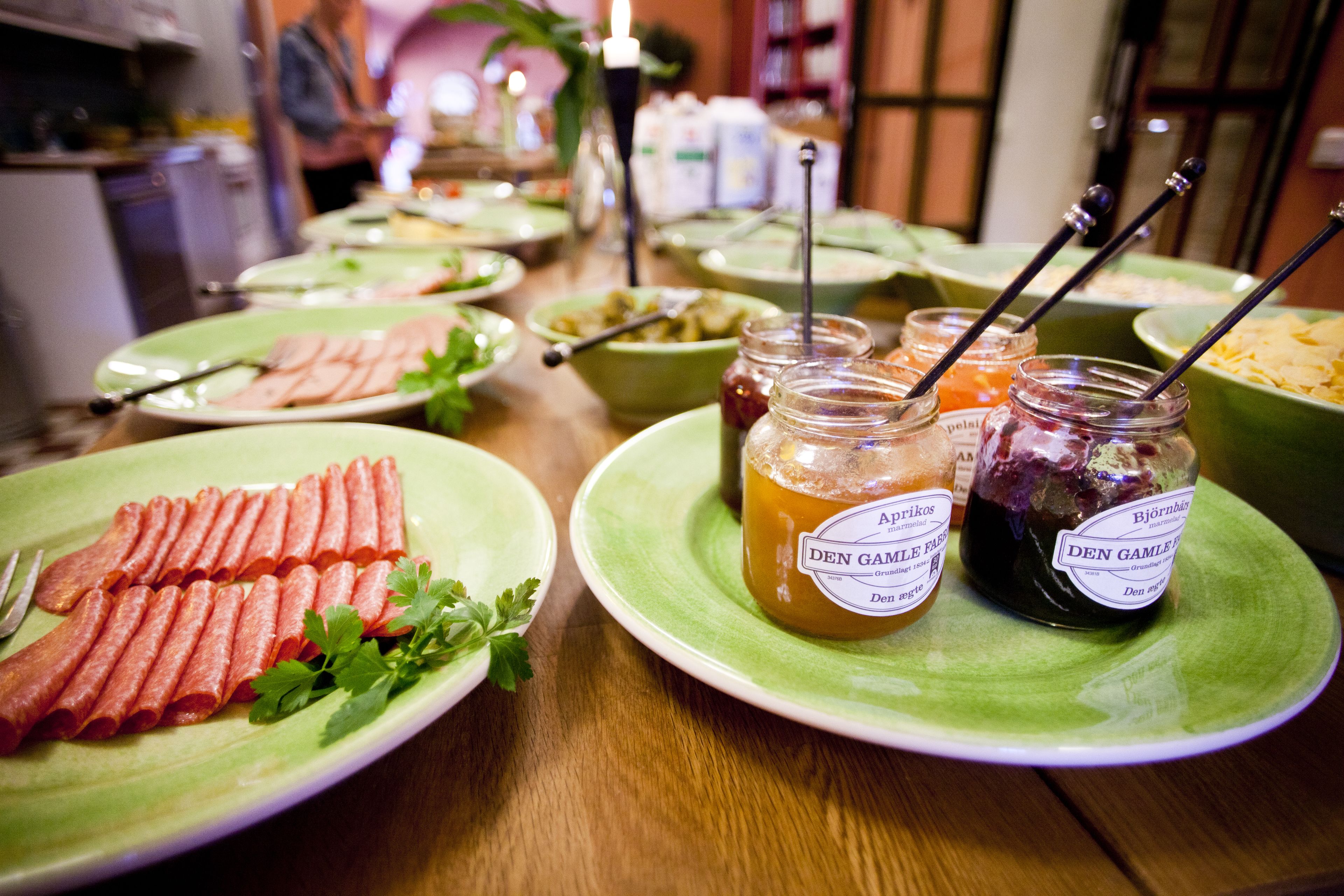 A buffet table with various food items and condiments.