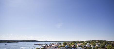 A harbor with boats, buildings, and a clear sky.
