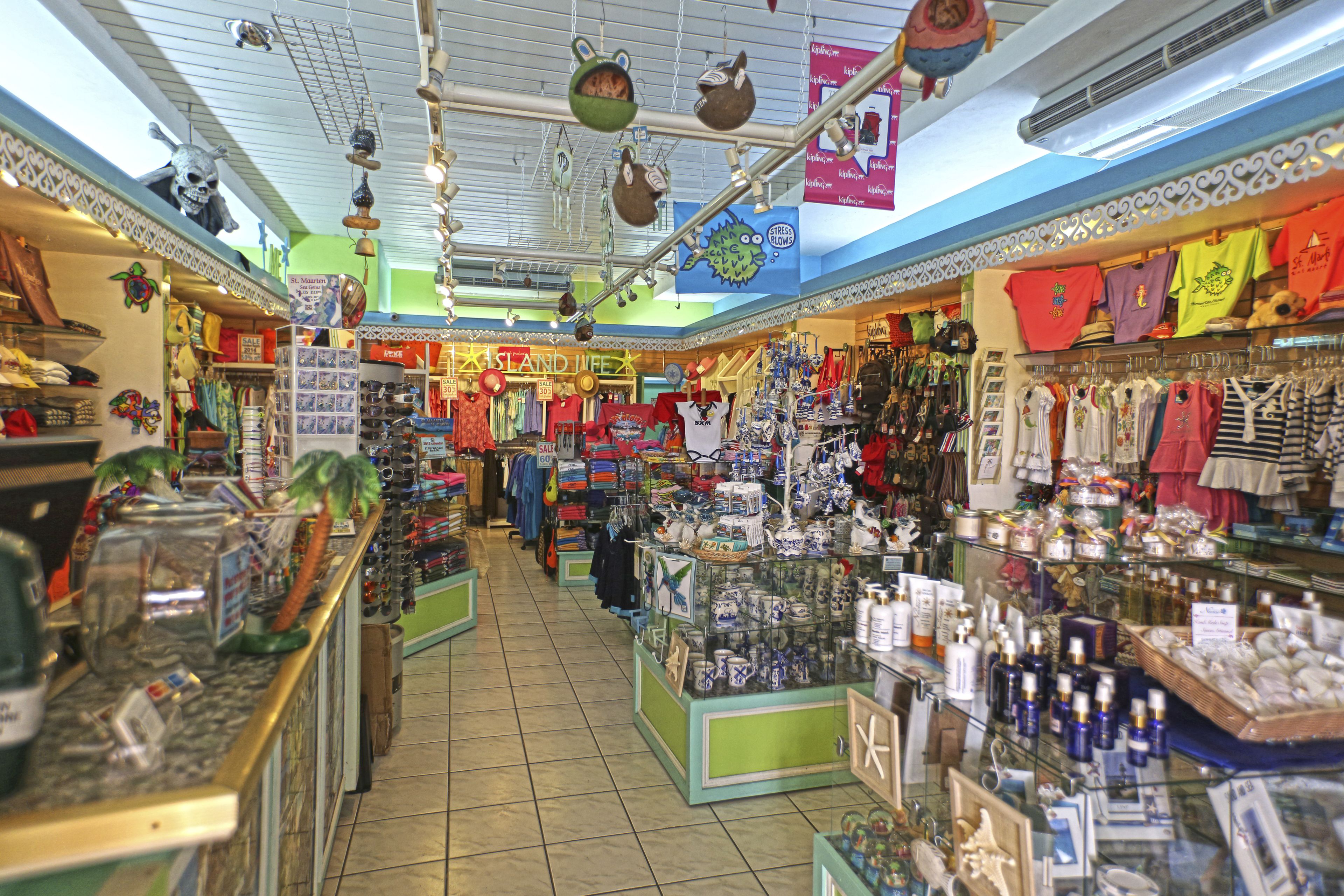 A brightly lit souvenir shop with various items on display, including clothing and decorative objects.