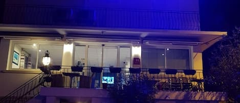A hotel with a prominent illuminated sign reading "Carry Hotel".