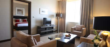 Premium Suite, 1 King Bed | Living room | Flat-screen TV