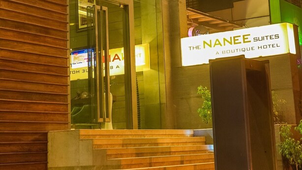 The Nanee Suites, a boutique hotel with a modern facade, illuminated signage, and a welcoming entrance. - The Nanee Suites (New Delhi)