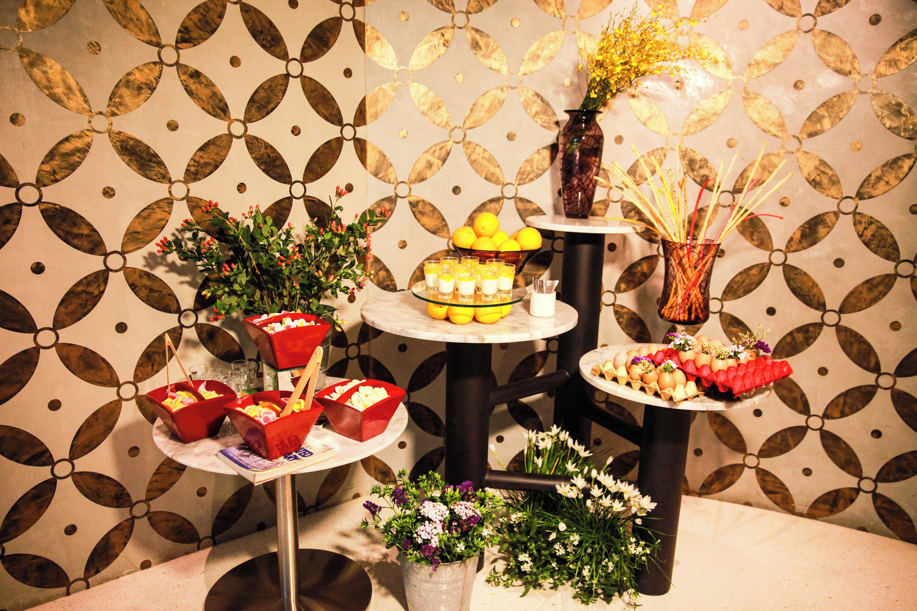A table with various food items and floral decorations.