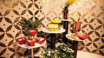A table with various food items and floral decorations.