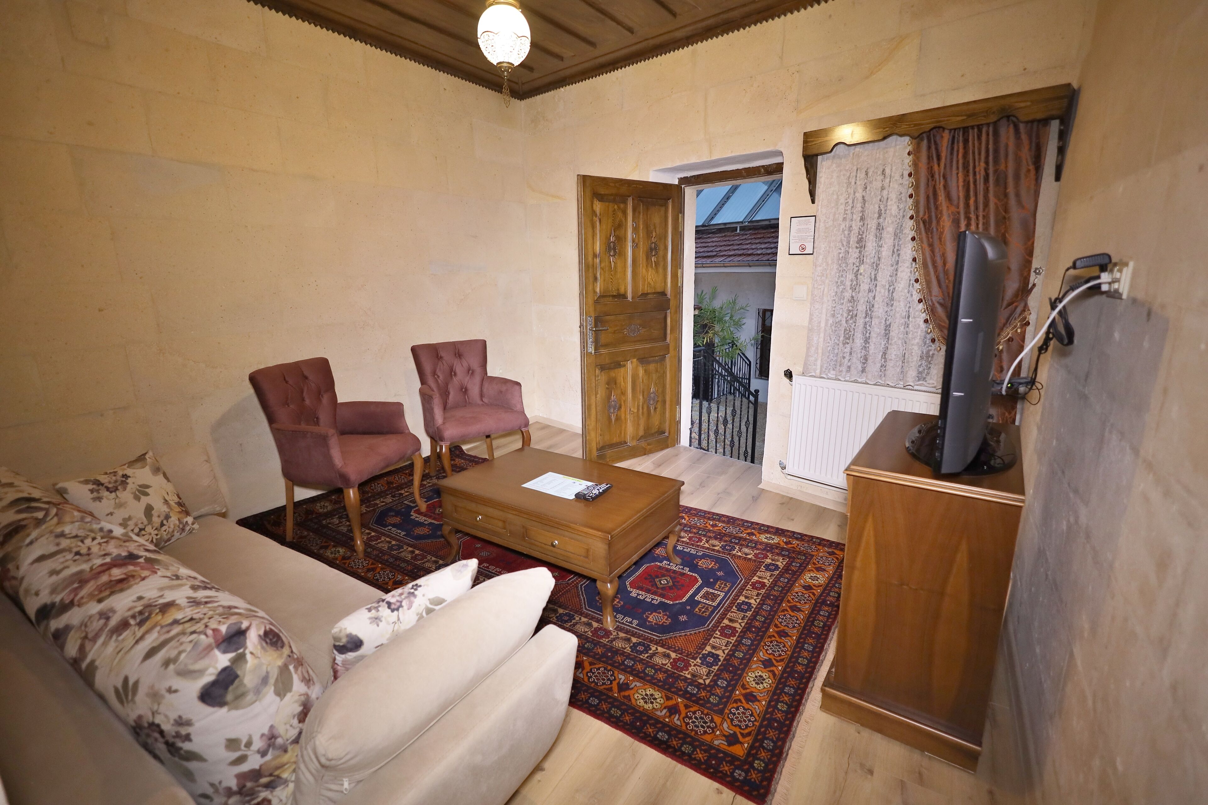 family suite, 1 queen bed, city view, courtyard area | living area | 61-cm tv with satellite channels