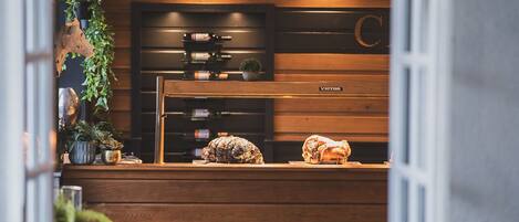 An open kitchen with wooden cabinets, a countertop with decorative items, and a visible door leading to another room.
