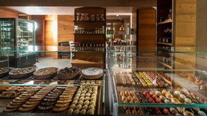 A bakery with a variety of baked goods displayed in glass cases. - Sottovento Luxury Hospitality (Bormio)