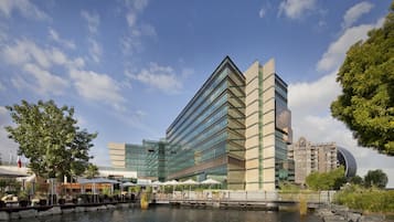 Experience the unique blend of modern and traditional architecture at this waterfront hotel, featuring a dock and outdoor seating areas.