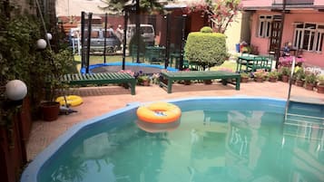 Seasonal outdoor pool, pool loungers