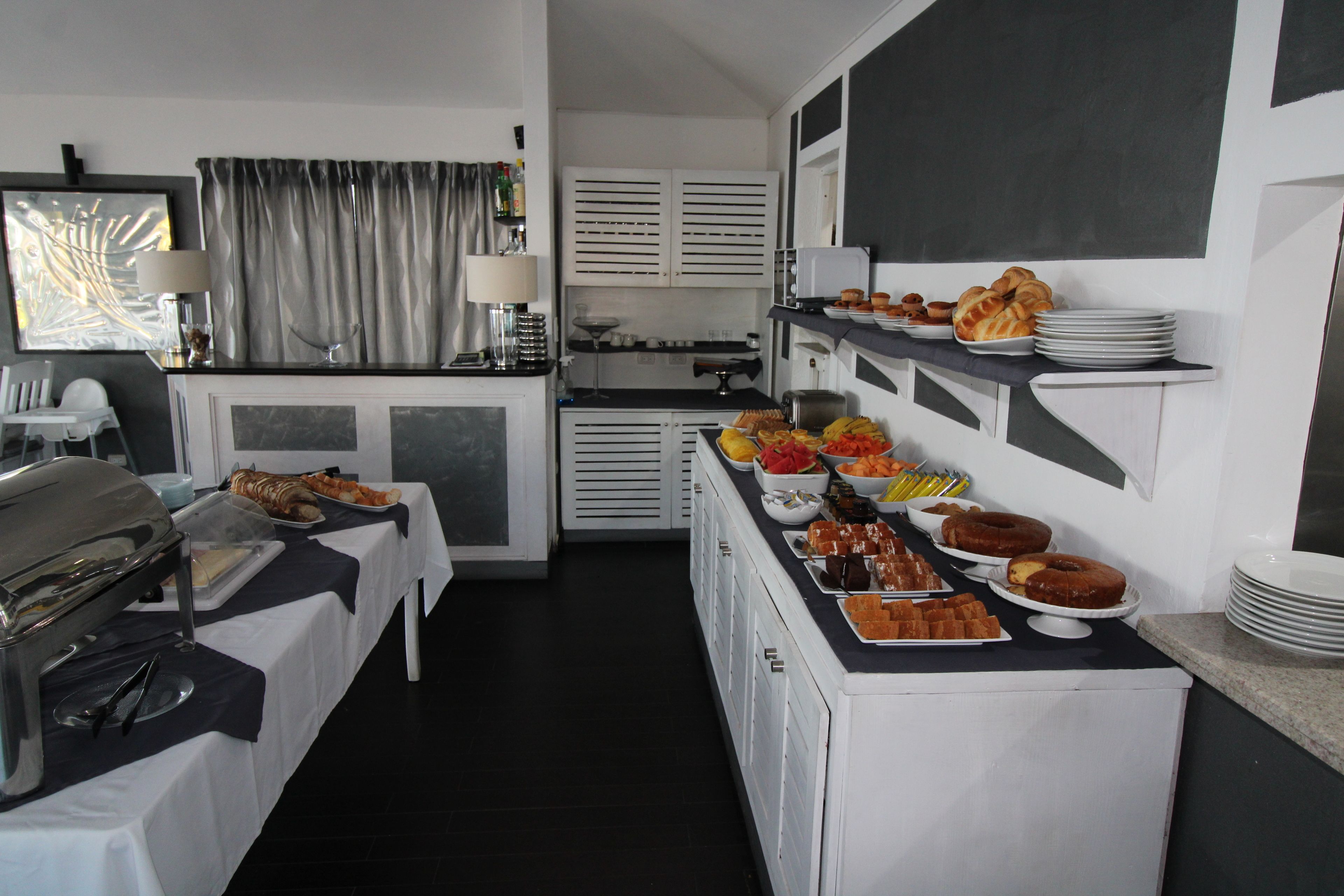 A buffet setup with various food items and a coffee station.
