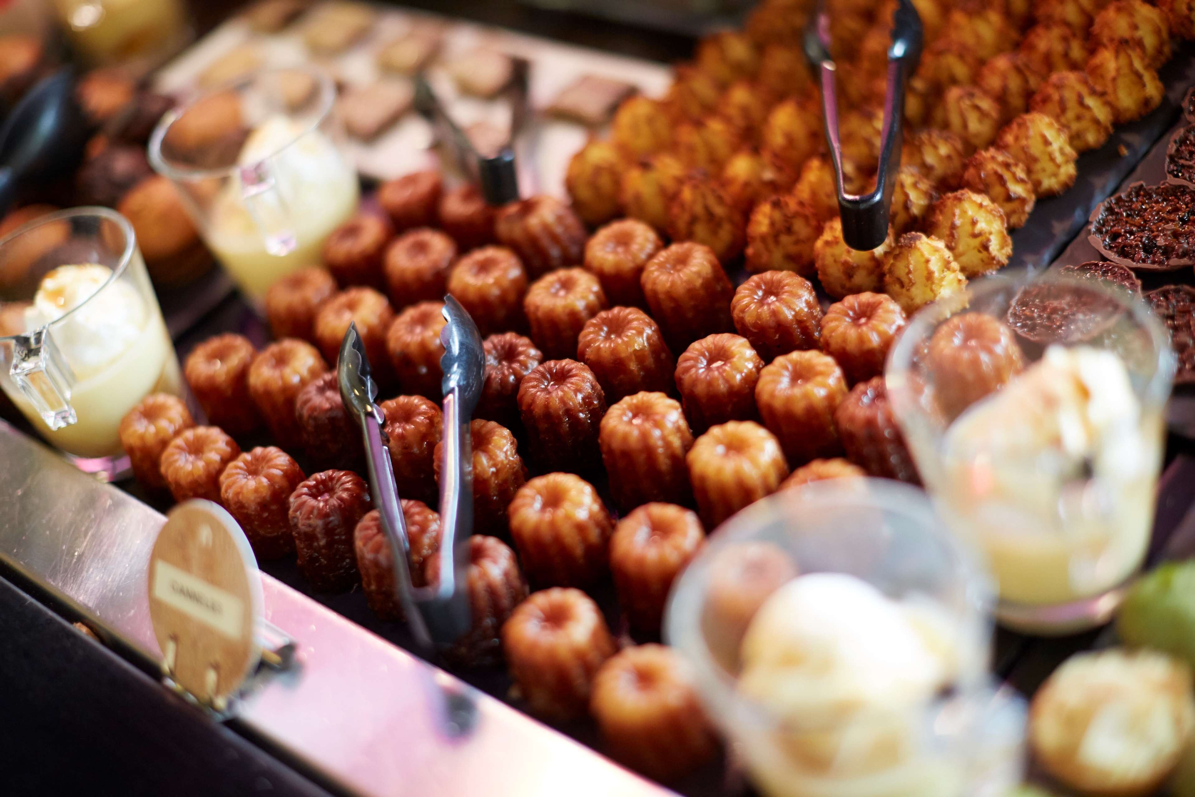 A variety of pastries and desserts displayed in a buffet setting.
