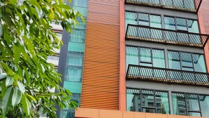 A modern building with a sign for 'Chill Table Kitchen & Bar' and 'The J Fusion Suite'. - The Fusion Suites (Bangkok)