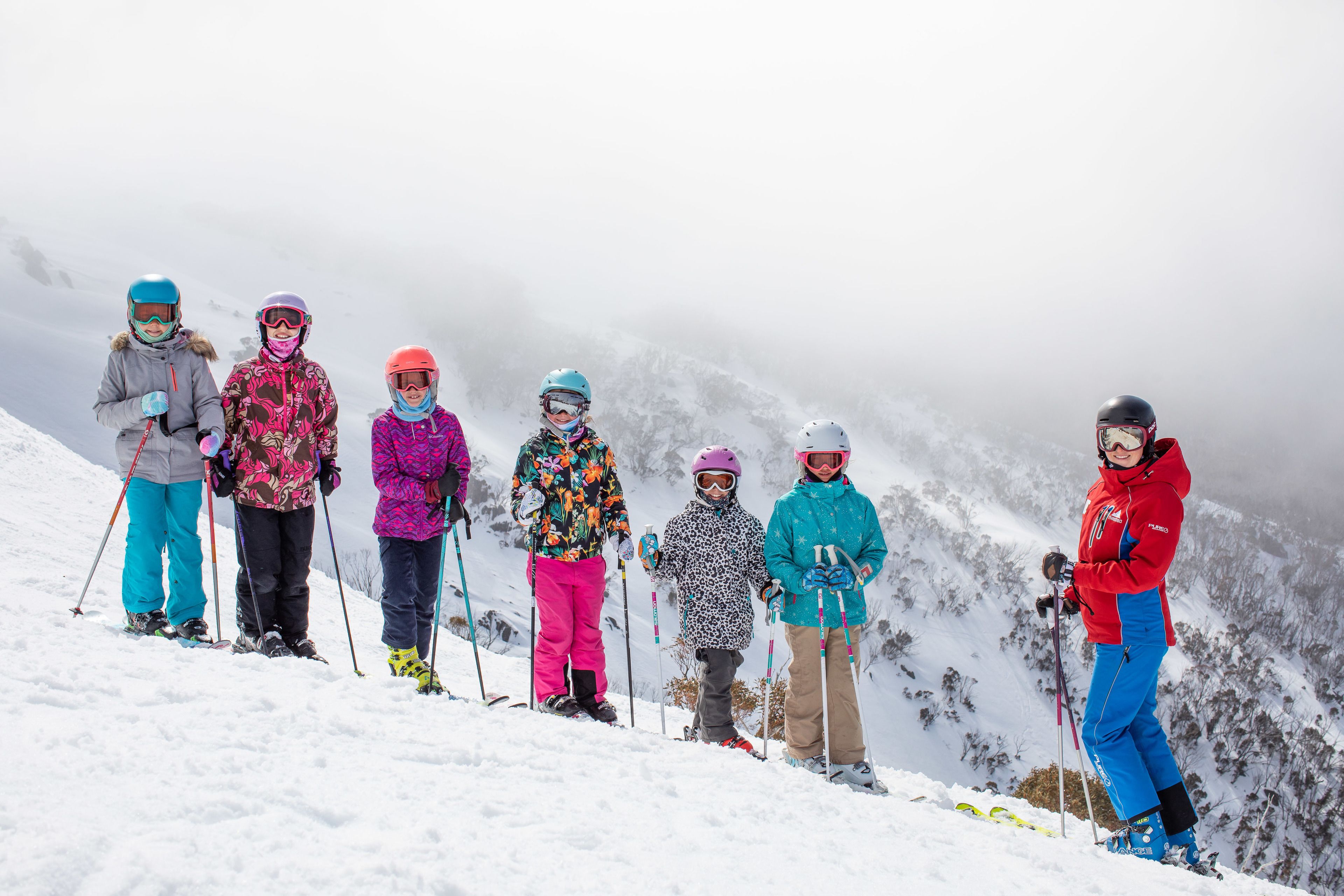 A group of skiers on a snowy mountain slope.