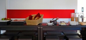 A buffet setup with various food items and a decorative vase. - Heckenrose (Ringsheim)
