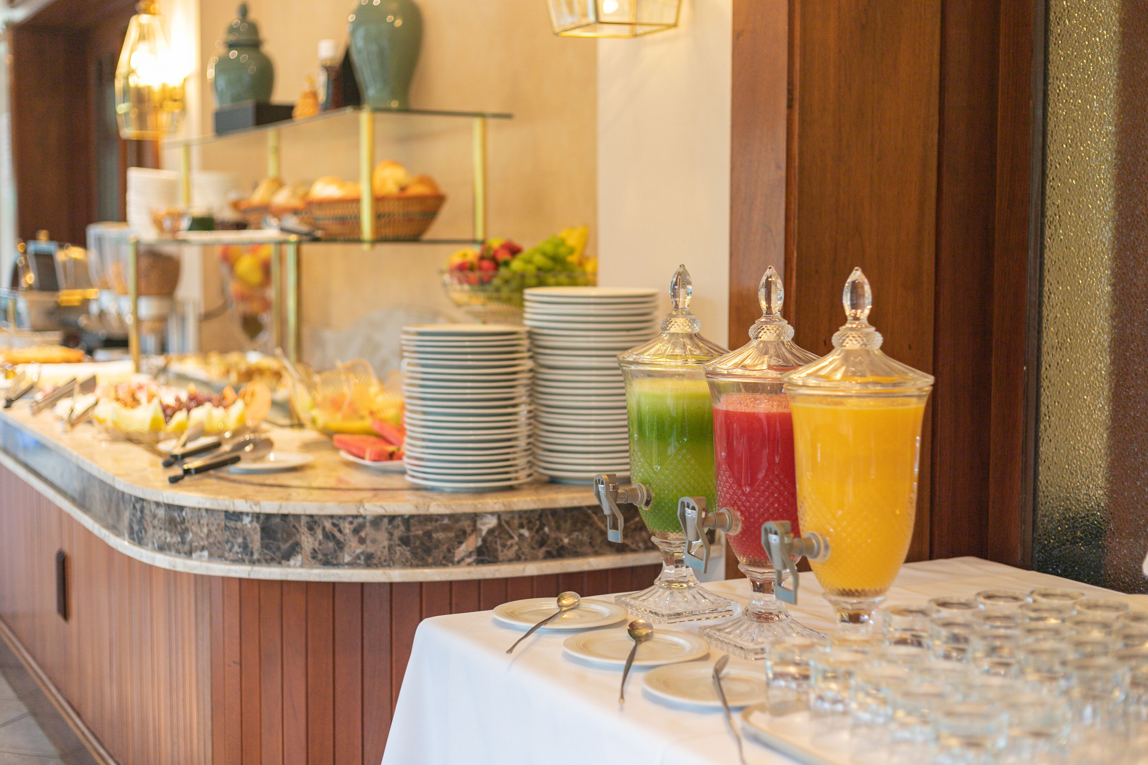 A buffet setup with various food items and drinks.